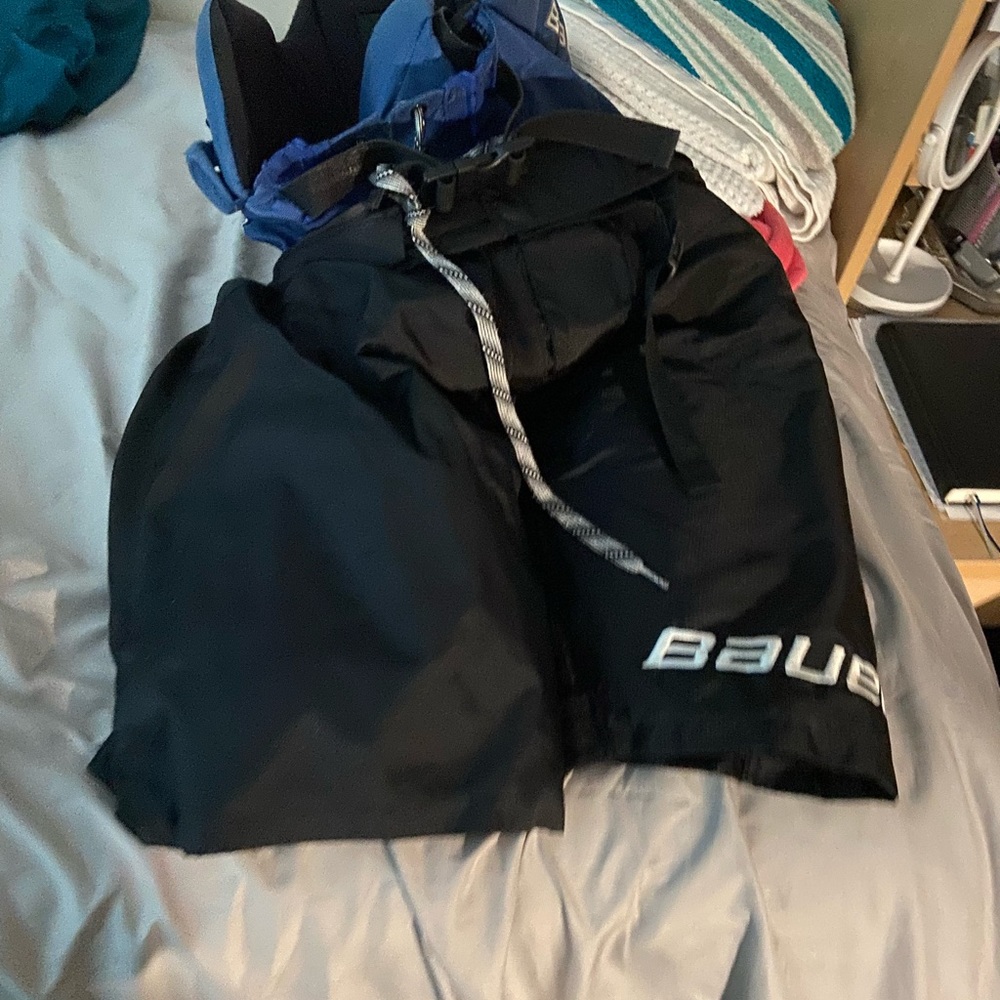 Bauer hockey pant covers in black.